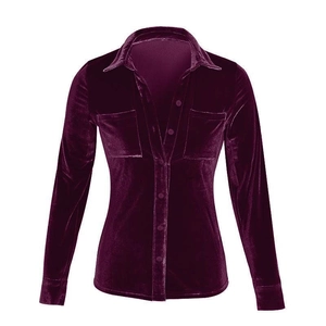 Detail of burgundy velvet shirt featuring classic collar, front buttons and chest pockets