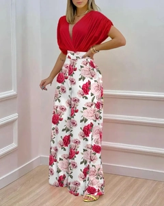 Détail d'un ensemble femme avec haut rouge à col en V et pantalon large à motif roses