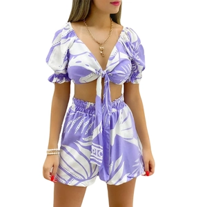 Detail of V-neck tie-front crop top and high-waist shorts in purple tropical leaf print
