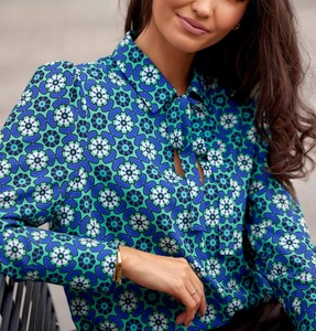 Detail of elegant emerald green geometric print blouse with pussy bow neck tie
