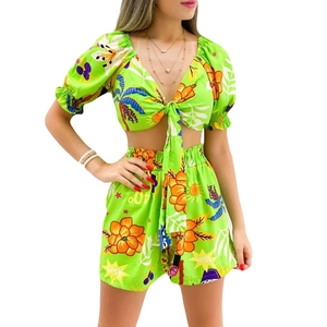 Detail of lime green tropical floral print two-piece summer set with tie-front top and shorts