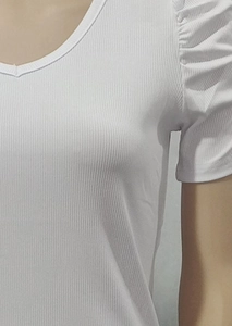 Close-up of white ribbed fabric V-neck T-shirt with stylish puff short sleeves on mannequin