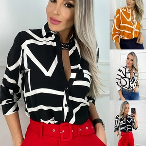 Detail view of long-sleeve shirts with geometric prints in black, orange, and white tones