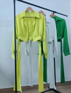 Detail of long sleeve cropped shirts with tie-waist and textured fabric in multiple colors