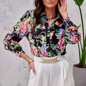 Elegant black long-sleeve floral shirt with colorful flower patterns and white wide-leg pants