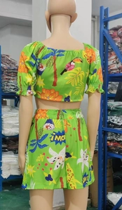 Rear view of vibrant green tropical print set featuring high-waisted shorts and crop top