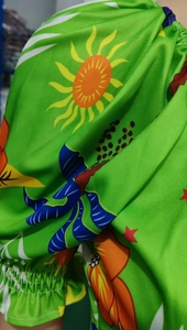 Close-up of vibrant floral print fabric with elastic pleated cuff and star patterns