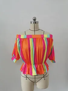 Detail of colorful vertical stripes on off-shoulder blouse with elastic waist and cuffs