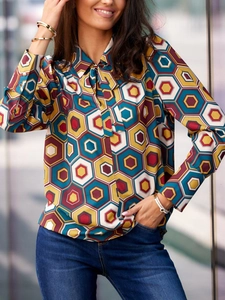 Elegant geometric print tie-neck blouse with mustard yellow and navy pattern for women