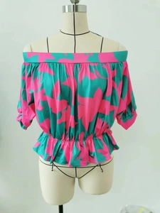 Detail of floral off-shoulder top with smocked waist and turquoise pink flower patterns