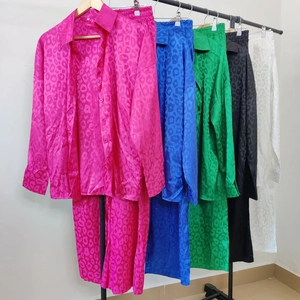 Detail view of satin leopard print pajamas in rose, blue, green, black and white colors