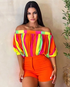 Detail of off-shoulder multi-color striped top and high-waist orange shorts summer set