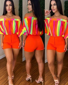 Detail of off-shoulder colorful striped top with high-waisted orange shorts set