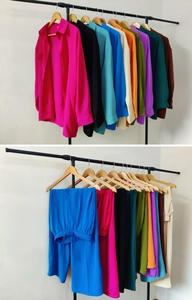 Detailed texture of women loose long-sleeve shirt and matching trousers set in various colors