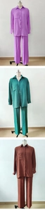 Detailed close-up of three long-sleeved button-down shirts and matching high-waist pants