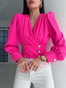 Detail of rose red V-neck blouse featuring double-breasted waist and lantern sleeves