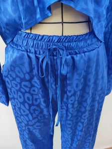 Detail view of royal blue leopard jacquard satin set with elastic drawstring waist