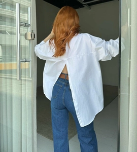Detail of white long sleeve shirt showing unique buttoned back slit design for women