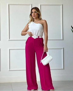 Detail of high-waisted fuchsia wide-leg trousers with elegant white button belt