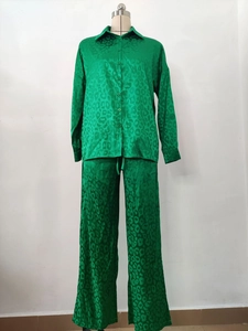 Detail of green leopard print satin shirt and wide-leg trousers on mannequin