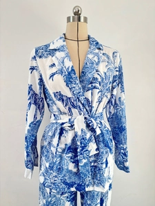 Detail of blue and white tropical tiger print on long-sleeved tie-front satin suit