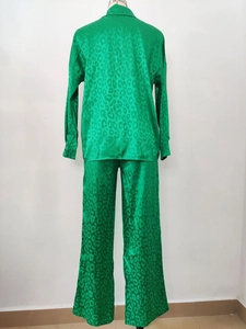 Rear view of green satin pajama set with subtle leopard jacquard on mannequin