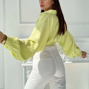 Women's pleated neon green tie-up shirt with long sleeves and textured fabric