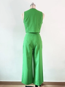 Rear view of women's sleeveless green vest and high-waisted wide-leg trousers set