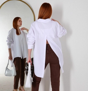 Detail view of white long-sleeved shirt featuring a unique buttoned back-slit design