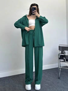 Detail of dark green women's lounge set with long-sleeved shirt and elastic waistband pants