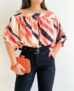 Detailed view of colorful striped off-the-shoulder summer blouse with pleated texture