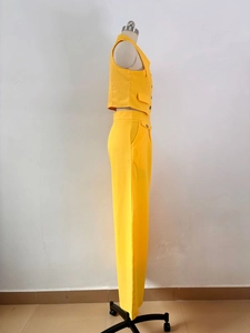 Side view of bright yellow two-piece suit with sleeveless vest and straight trousers
