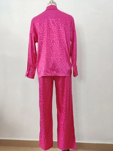 Close-up of the smooth fuchsia leopard print satin fabric on the long sleeve shirt back