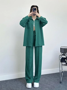 Detail of dark green two-piece lounge set with drawstring waist and textured fabric