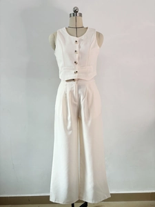 Detail of off-white sleeveless blazer vest and high-waisted wide-leg trousers set