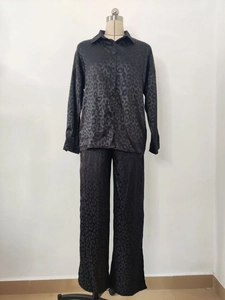 Detail of black leopard print satin lounge set showing shirt collar and fabric texture