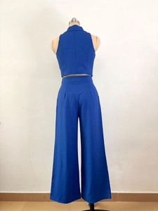Rear view of royal blue two-piece set featuring a cropped sleeveless vest and wide-leg pants