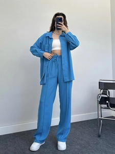 Women's bright blue two-piece set featuring long sleeve shirt and wide leg trousers