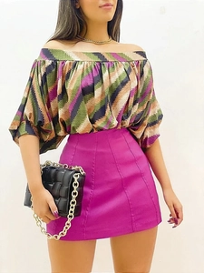 Detail of off-shoulder striped top with puff sleeves and purple high-waist A-line skirt