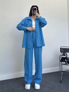 Detail of blue textured fabric on casual long sleeve shirt and wide leg trousers set