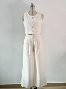 Detailed view of white two-piece set featuring a V-neck vest and high-waist wide-leg trousers