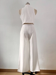 Detail of white two-piece summer set showing back design of sleeveless top and wide trousers