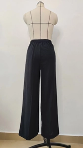 Back view detail of black wide-leg trousers featuring an elastic high waistband