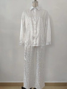 Detailed view of white two-piece set featuring leopard jacquard texture and button-up shirt
