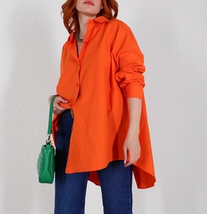 Oversized bright orange button-up shirt featuring a classic collar and a loose casual fit