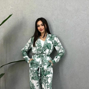 Detail of white satin long-sleeve casual set featuring tropical green nature landscape print