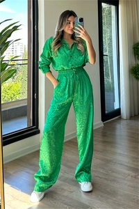 Detail of green leopard print satin set showing drawstring elastic waist and fabric texture