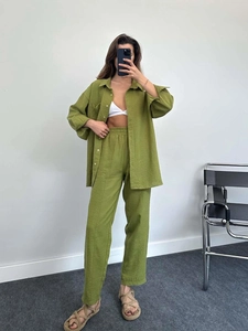 Detail view of olive green casual two-piece set with pleated texture and button-up shirt