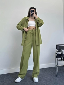 Close-up of olive green three-piece set featuring textured fabric and relaxed fit