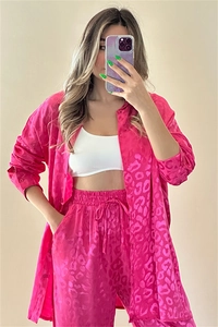 Detail of rose pink leopard jacquard shirt and trousers set with smooth satin texture